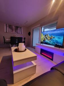 a living room with a large flat screen tv at Ferie leiligheten ved stranden in Kristiansand