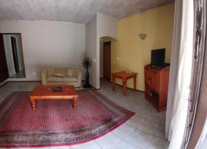 a living room with a couch and a coffee table at Guest House Oaktree fourways in Sandton