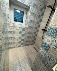 a bathroom with a shower with a window at Vacation Home Rovanjska in Rovanjska