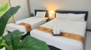 Giường trong phòng chung tại V Rich วีริชเพลส ร้อยเอ็ด