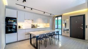 a kitchen with a table and some chairs in it at Oasis Retreat Lux and Elegance in Fethiye