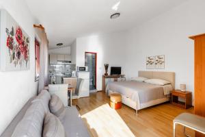 a bedroom with a bed and a living room at Apartments Papic in Vrsi