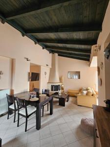 a living room with a table and a couch at Marily's seaview suite with private JACUZZI and BBQ in Spartià