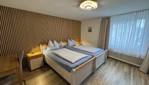 Postel nebo postele na pokoji v ubytování Hotel Stadt Soest