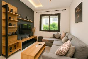 a living room with a couch and a table at Atelier Aedes - Studio 1 in Maarif