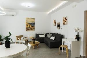 a living room with a couch and a table at StelAnna-Apartments in Rethymno Town