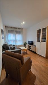a living room with a couch and a table at Apartamento Cantabria Verde in Los Corrales de Buelna