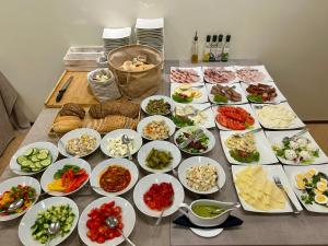 a table topped with lots of different dishes of food at Hotel Kazimierz II in Krakow
