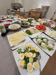 a table with many plates of food on it at Hotel Kazimierz II in Krakow +21 photos