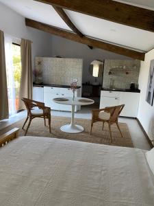 a room with a bed and a table and chairs at As Casas Do BomPai - Eira in São Julião