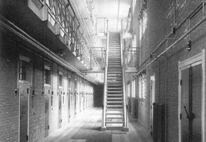 a hallway with a staircase in a building at De oude gevangenis Almelo in Almelo