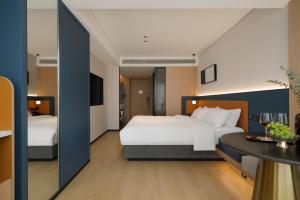 Postelja oz. postelje v sobi nastanitve Chongqing Jiefangbei Jiayu Hotel