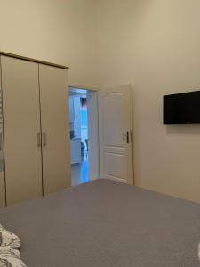 a bedroom with a bed and a flat screen tv at Holiday Home Panorama in Zubovići