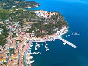 an island with a harbor with boats in the water at Casa Romita 9 - ArgonautiVacanze in Porto Azzurro