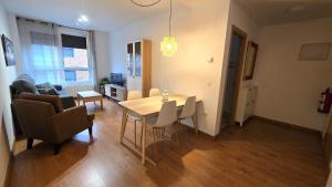 a living room with a dining room table and chairs at Apartamento Cantabria Verde in Los Corrales de Buelna
