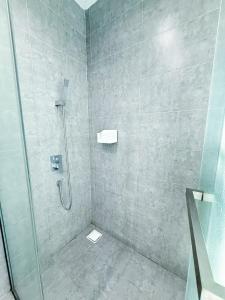 a bathroom with a shower with a glass door at The Square One City Mall Premium Family 3R2B 8pax by Luvit Stay in Subang Jaya