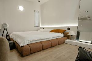 a bedroom with a large bed and a television at Do Studioishome Homestay Dukkha 03 in Ha Long