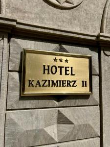a sign on the side of a building at Hotel Kazimierz II in Krakow