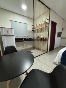 a room with a table and chairs and a large window at Pousada Solare Home in São Miguel do Gostoso