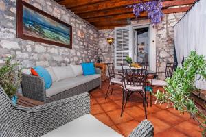a patio with a couch and a table and chairs at Tiny House Fuma in Rovinj