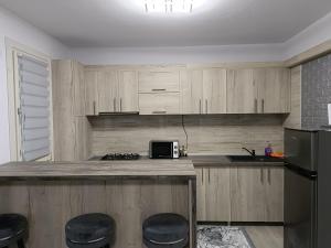 a kitchen with a counter with a microwave and a refrigerator at GH Apartments 1 in Gura Humorului