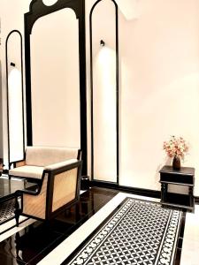 a living room with a chair and a table at Mia Garden Hotel in Dinh Ðiền Buôn Hô +20 photos