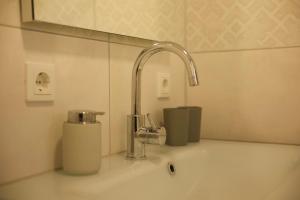 a sink with a faucet in a bathroom at Charmantes Luxus Maisonette- Apartement in Bad Hersfeld +119 photos