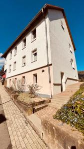 a large white building with steps in front of it at Charmantes Luxus Maisonette- Apartement in Bad Hersfeld