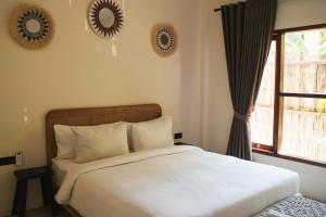 Ένα ή περισσότερα κρεβάτια σε δωμάτιο στο Java Villa Lombok