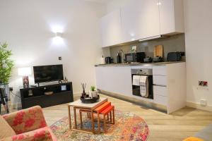 a living room with a couch and a table at Urban Living I Free Parking in Slough +38 photos