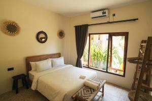 Ένα ή περισσότερα κρεβάτια σε δωμάτιο στο Java Villa Lombok