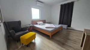 a small room with a bed and a chair at Stay in Herzogenaurach 1 Zimmer Apartment in Herzogenaurach
