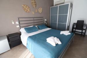 a bedroom with a bed with two towels on it at Fasthotel in Cervia