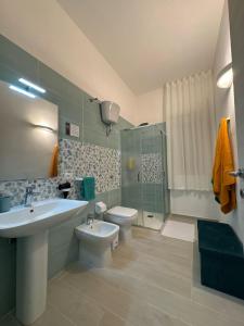 a bathroom with a sink and a toilet and a shower at La Casa di Armando in Agrigento