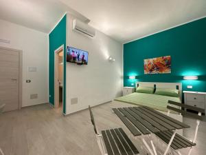 a bedroom with a bed and a green wall at La Casa di Armando in Agrigento +3 photos