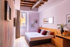 Postel nebo postele na pokoji v ubytování DownTown Boutique House - CA Domus Collection