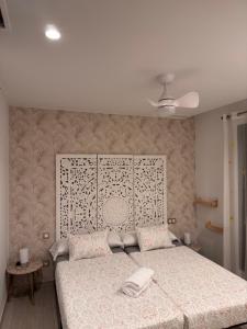 a bedroom with a bed with a large headboard at Villa Finestrat Benidorm Golf y Playa in Cala de Finestrat +37 photos