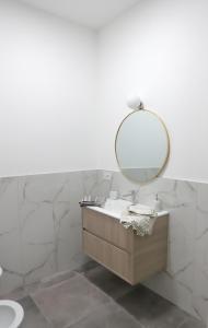 a bathroom with a sink and a mirror at Valeria Apartment in Monza +18 photos