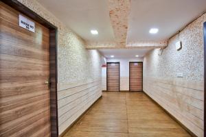 a corridor with wooden doors in a building at Aveeno Resort & Villas Near Calangute and Baga in Jāmb