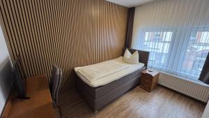 Postel nebo postele na pokoji v ubytování Hotel Stadt Soest