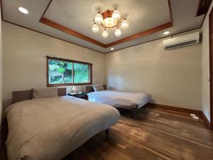 Ένα ή περισσότερα κρεβάτια σε δωμάτιο στο 鎌倉関邸