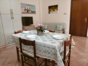 a dining room table with a white table cloth at Casa Giuliana in Pula