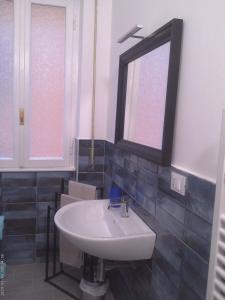 a bathroom with a sink and a mirror at Casa di Alby in Rapallo