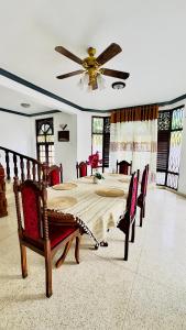 a dining room with a table and a ceiling fan at Yahana Beach Villa in Negombo +28 photos