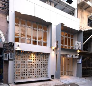 a building with a large door with the number at BEAT Warii Hostel at Chaophraya River in Bangkok