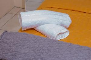 a roll of toilet paper sitting on a bed at Holiday Home, Zimre Park, Harare, Zimbabwe in Harare +44 photos