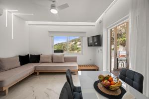 a living room with a couch and a table at Dora Apartments in Agia Pelagia