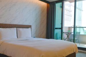 Postel nebo postele na pokoji v ubytování 嬉安平 Si Anping by Hotel Si