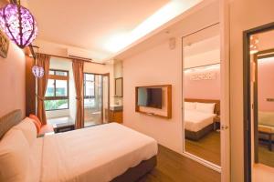 Postel nebo postele na pokoji v ubytování 嬉安平 Si Anping by Hotel Si