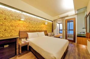 Postel nebo postele na pokoji v ubytování 嬉安平 Si Anping by Hotel Si